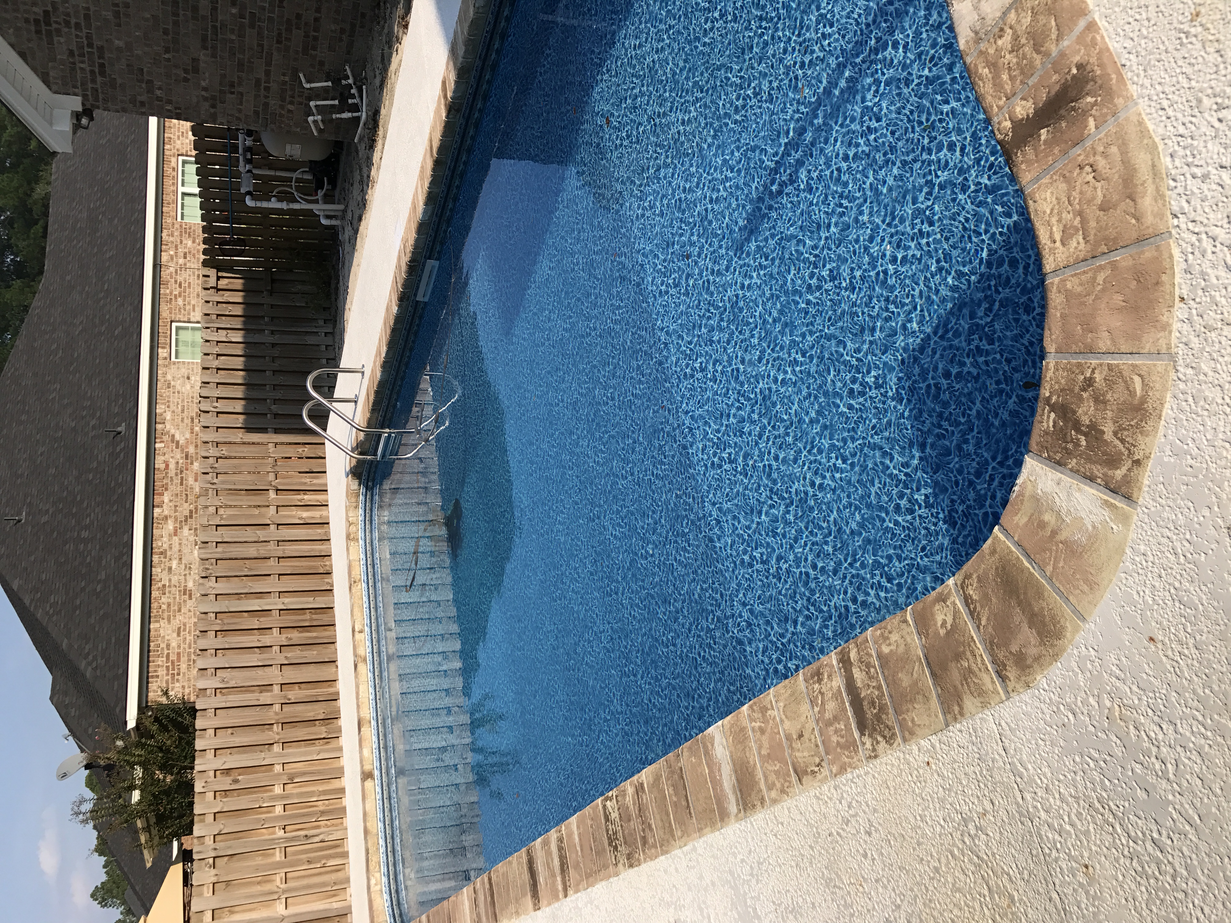 Pool deck concrete coating with stone border Hinesville GA